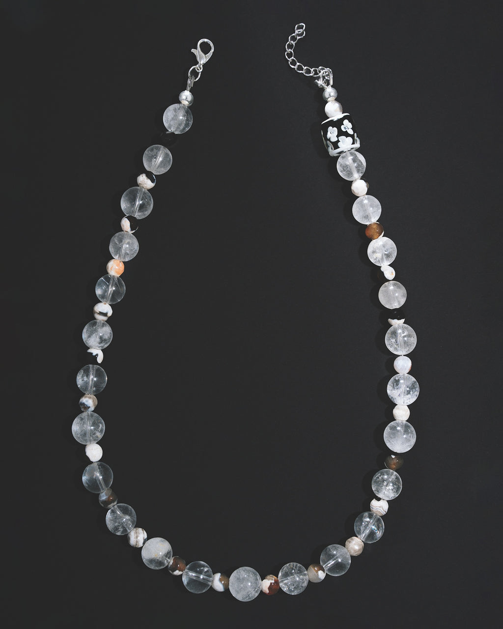 Beaded necklace with clear and white beads on a black background handmade unisex Paris mansa editions 