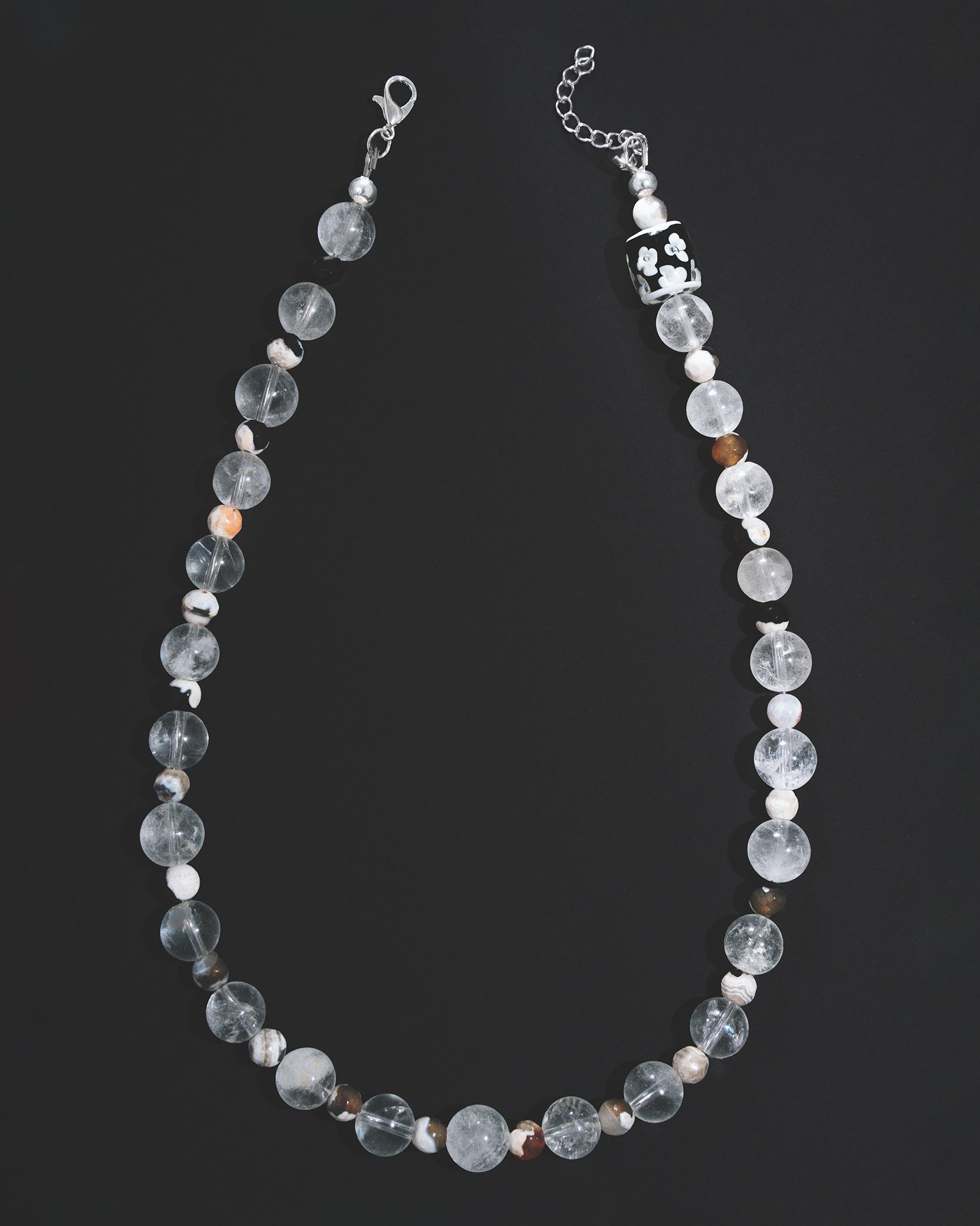Beaded necklace with clear and white beads on a black background handmade unisex Paris mansa editions 