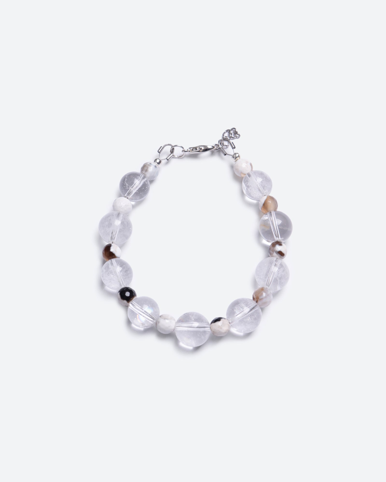 Unisex bracelet with clear crystal beads mixed with smaller brownish beads on a white background