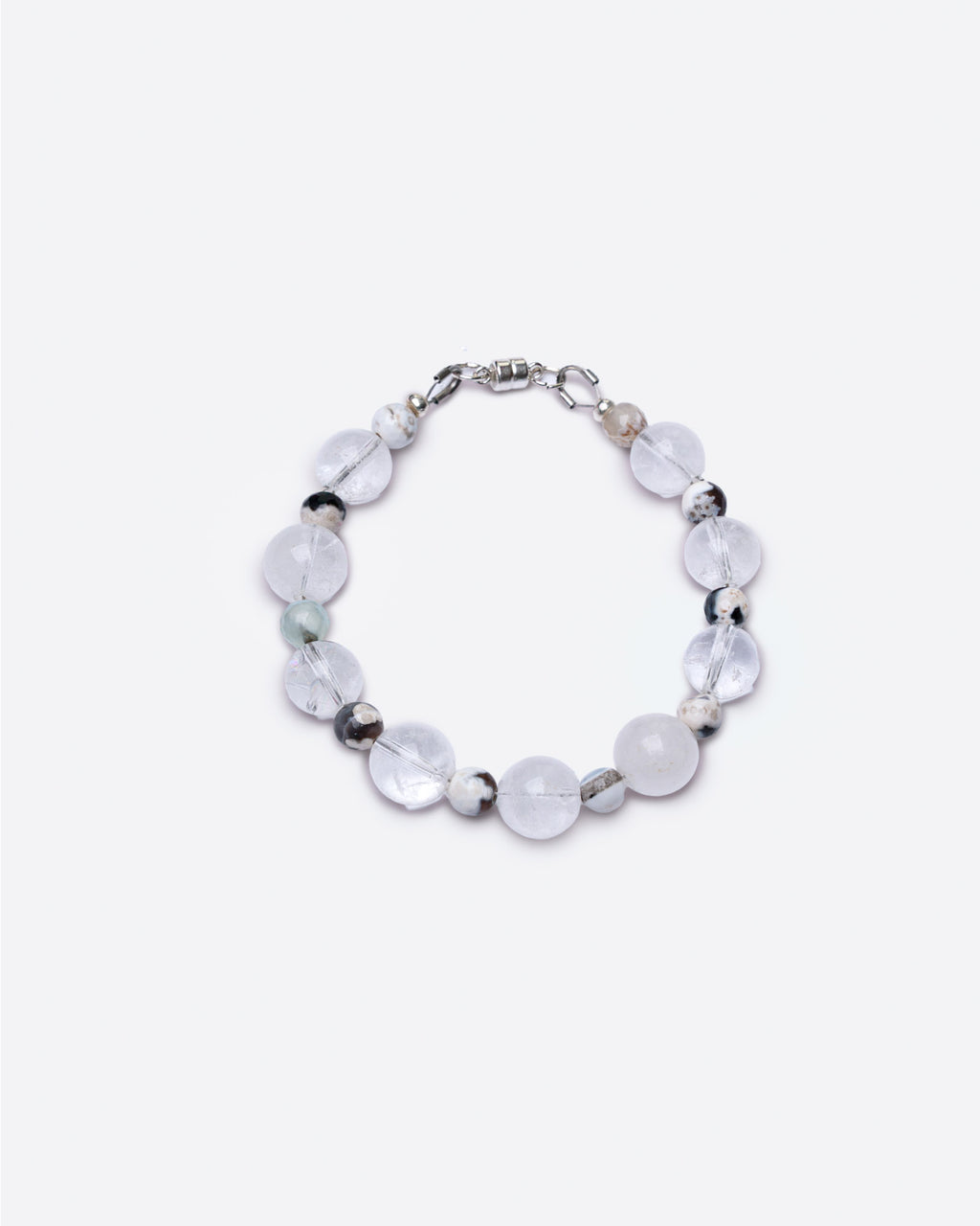 Bracelet with round glass transparent and brown fire agate beads on a white background