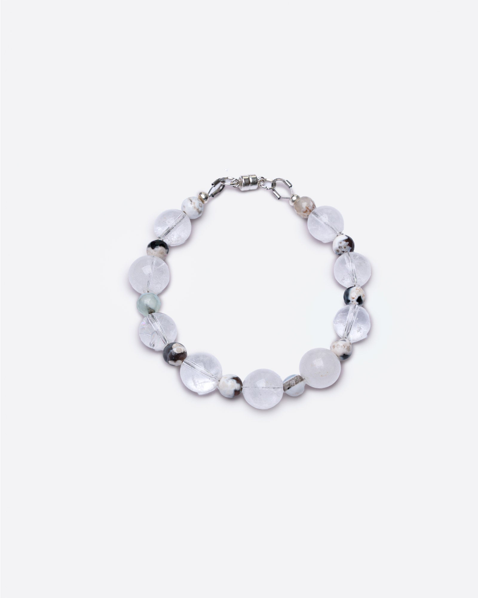 Bracelet with round glass transparent and brown fire agate beads on a white background